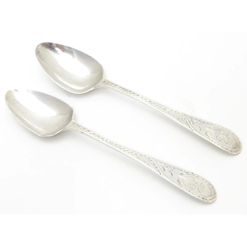 281 - A pair of Geo III Old English pattern teaspoons with bright cut decoration to handles. Hallmarked Lo... 