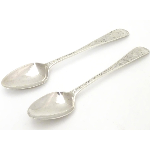 281 - A pair of Geo III Old English pattern teaspoons with bright cut decoration to handles. Hallmarked Lo... 