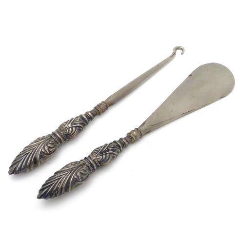 284 - A silver handled shoe horn and button hook. Hallmarked Birmingham 1906 maker Crisford & Norris Ltd. ... 