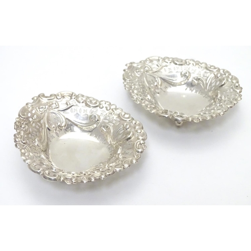 286 - A pair of late Victorian silver heart-shaped bonbon dishes with pierced and scroll decoration, each ... 