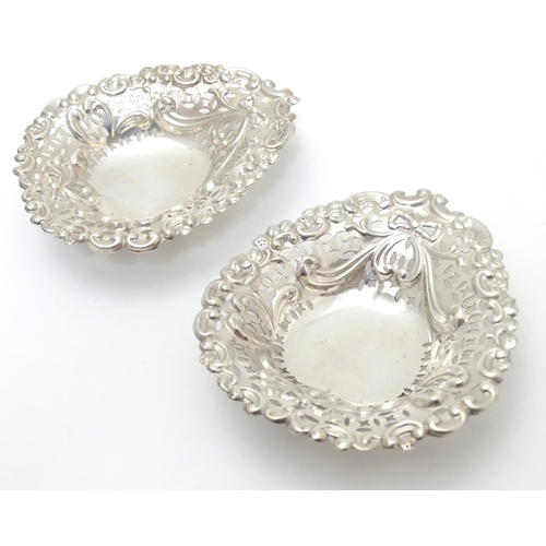 286 - A pair of late Victorian silver heart-shaped bonbon dishes with pierced and scroll decoration, each ... 