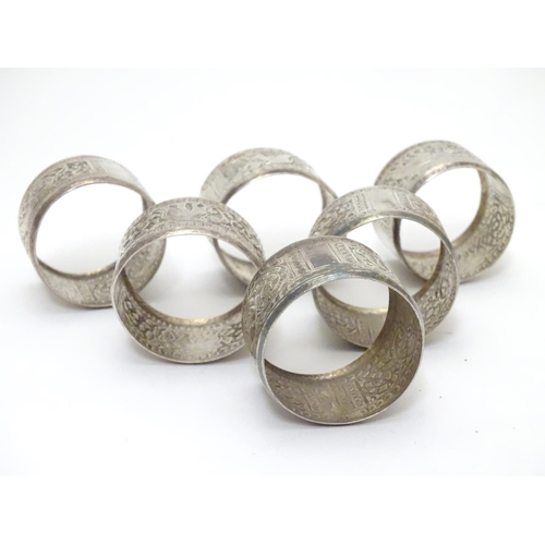 335 - A set of 6 Indian white metal napkin rings with elephant decoration.