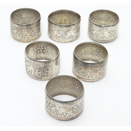 335 - A set of 6 Indian white metal napkin rings with elephant decoration.