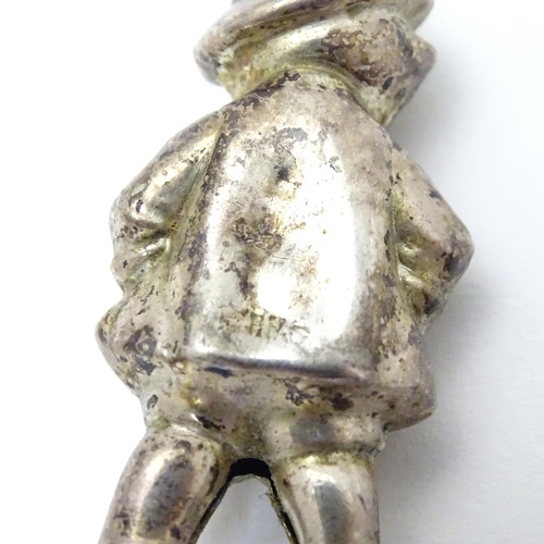 336 - A novelty silver plate rattle formed as a young child 2 1/4