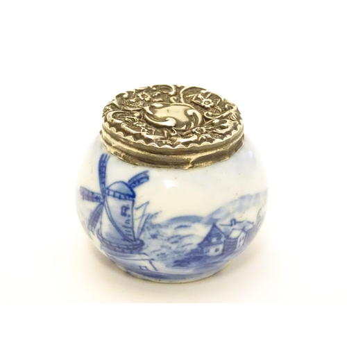 350 - An early 20thC ceramic pot with Dutch landscape decoration and silver lid hallmarked London c.1904. ... 