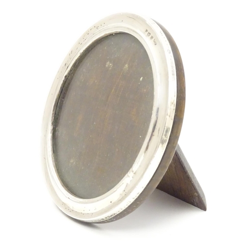 355 - A photograph frame of circular form with silver surround hallmarked Bimringhm1925 maker Sanders & Ma... 