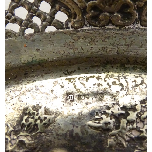 356 - A Continental silver dish of basket form with lattice decoration and cast cherub scene. 7 1/4