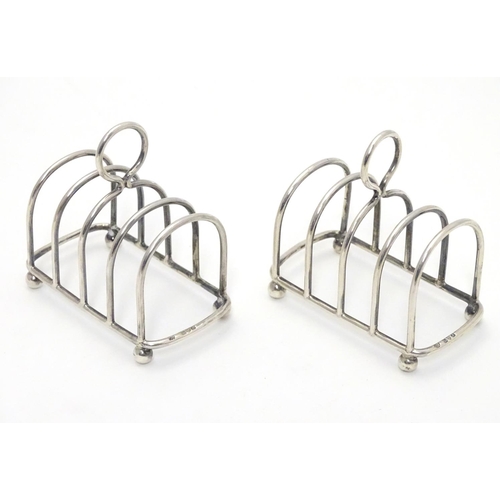 357 - Two 5 bar toast racks hallmarked 1909/1911 maker Haseler Brothers (Edward John Haseler & Noble Hasel... 