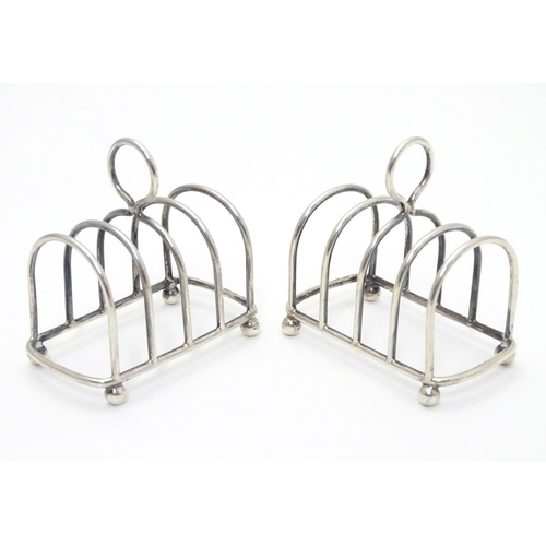 357 - Two 5 bar toast racks hallmarked 1909/1911 maker Haseler Brothers (Edward John Haseler & Noble Hasel... 