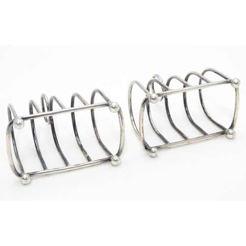 357 - Two 5 bar toast racks hallmarked 1909/1911 maker Haseler Brothers (Edward John Haseler & Noble Hasel... 