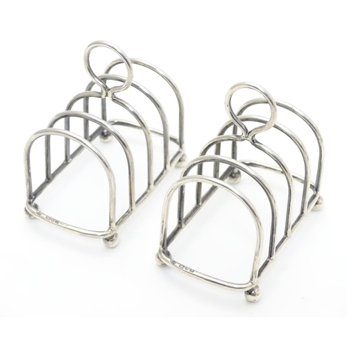 357 - Two 5 bar toast racks hallmarked 1909/1911 maker Haseler Brothers (Edward John Haseler & Noble Hasel... 