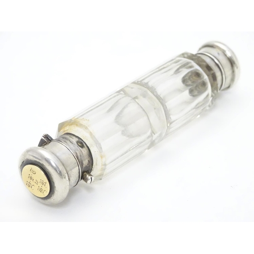 361 - A 19thC double ended scent bottle / flask the class body with white metal ends and yellow metal inse... 