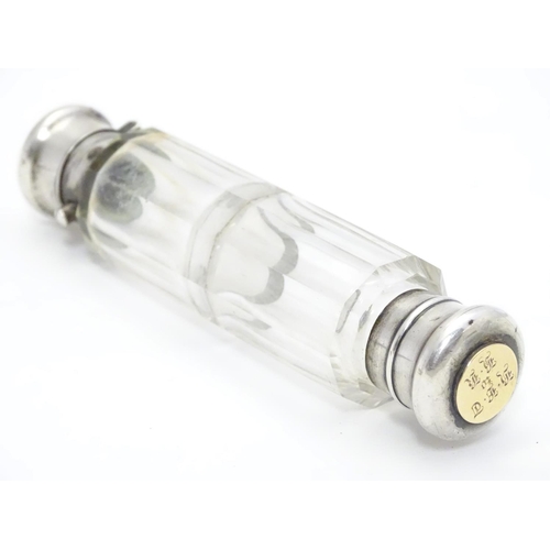 361 - A 19thC double ended scent bottle / flask the class body with white metal ends and yellow metal inse... 