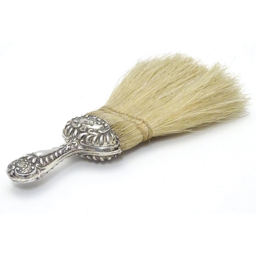 364 - A silver handled hat brush with embossed decoration. Hallmarked Chester 1902 maker J C Plimpton & Co