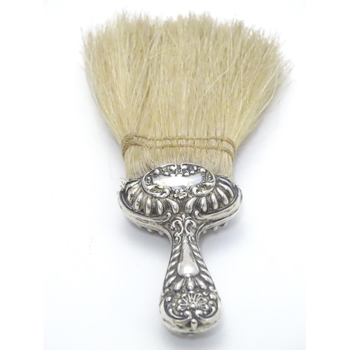 364 - A silver handled hat brush with embossed decoration. Hallmarked Chester 1902 maker J C Plimpton & Co