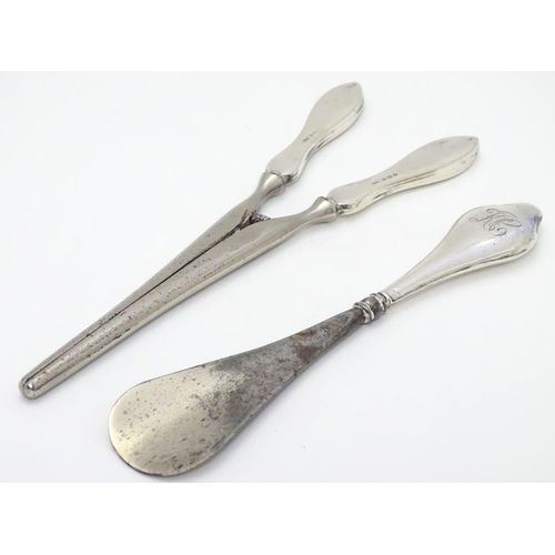 369 - A silver handled shoe horn together with silver handled glove stretcher . the largest 7 1/2