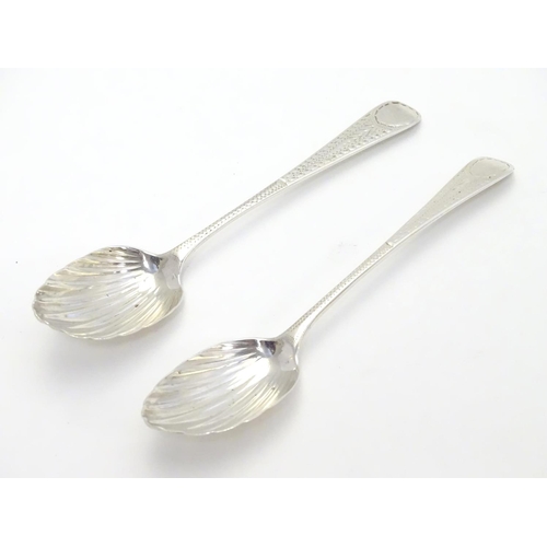 370 - Two Geo III silver teaspoons with shell formed bowls and bright cut decoration to handles. one hallm... 