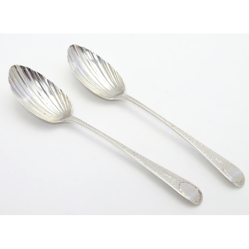 370 - Two Geo III silver teaspoons with shell formed bowls and bright cut decoration to handles. one hallm... 