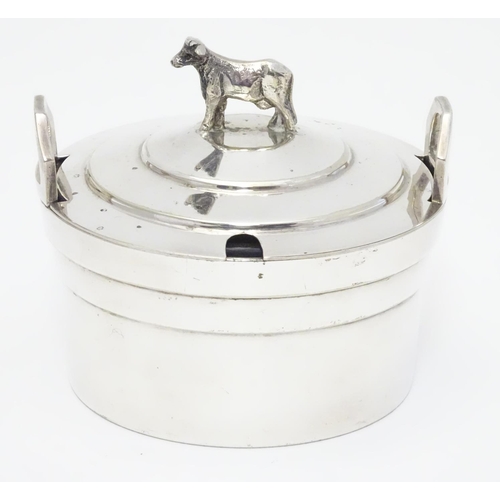 379 - A silver plate butter dish of circular form with glass liner, the lid with cow formed finial. 4