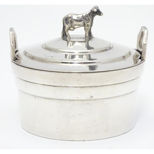 379 - A silver plate butter dish of circular form with glass liner, the lid with cow formed finial. 4