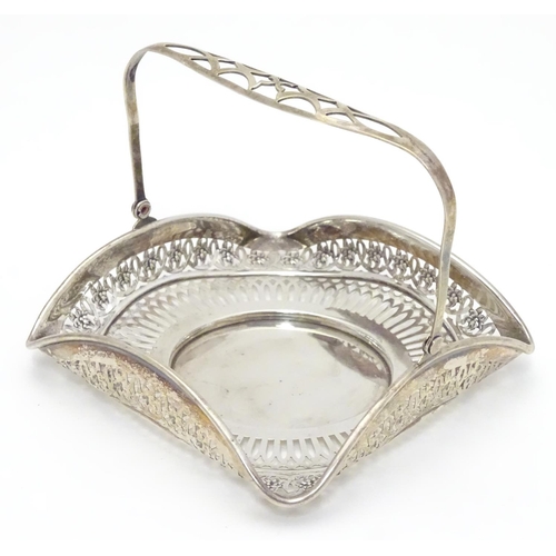 382 - An American Sterling silver swing-handled bonbon dish of square form with pierced decoration. Maker’... 