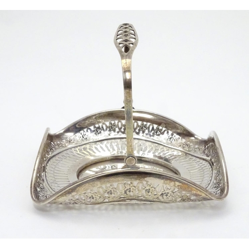 382 - An American Sterling silver swing-handled bonbon dish of square form with pierced decoration. Maker’... 