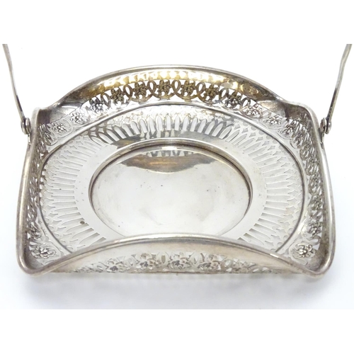 382 - An American Sterling silver swing-handled bonbon dish of square form with pierced decoration. Maker’... 