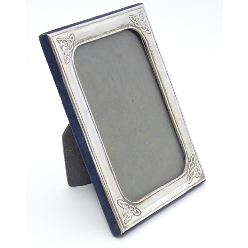 383 - An Irish photograph frame with silver surround having Celtic-style designs at each corner. Hallmarke... 