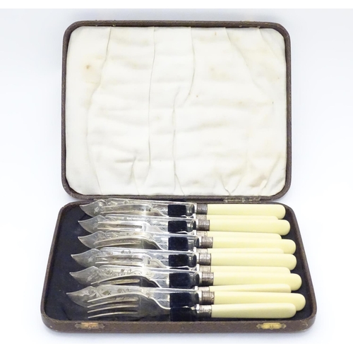 384 - A cased set of fish knives and forks (6+6), each with silver collar hallmarked Sheffield 1926 maker ... 