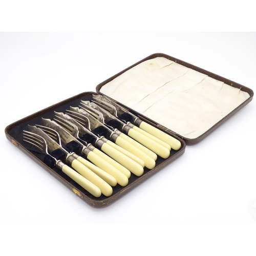 384 - A cased set of fish knives and forks (6+6), each with silver collar hallmarked Sheffield 1926 maker ... 