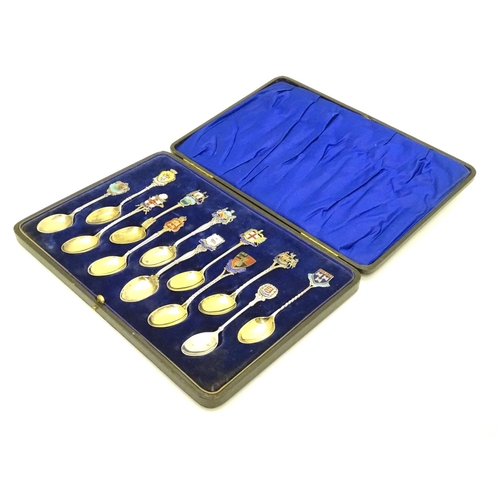 390 - 12 assorted silver souvenir teaspoons  with enamel direction to handles depicting town coat of arms ... 