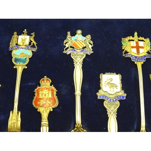 390 - 12 assorted silver souvenir teaspoons  with enamel direction to handles depicting town coat of arms ... 