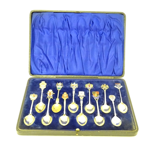 390 - 12 assorted silver souvenir teaspoons  with enamel direction to handles depicting town coat of arms ... 