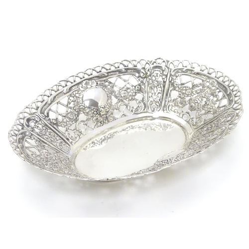 391 - A Continental 925 silver dish with pierced and repoussee floral decoration. Approx. 7” long