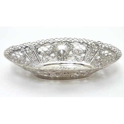 391 - A Continental 925 silver dish with pierced and repoussee floral decoration. Approx. 7” long