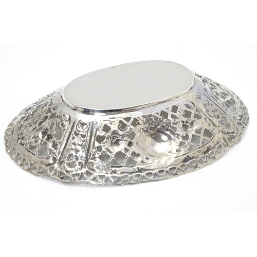 391 - A Continental 925 silver dish with pierced and repoussee floral decoration. Approx. 7” long