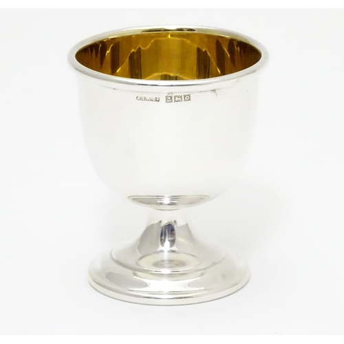 394 - A silver egg cup with gilded interior and weighted base. Hallmarked Birmingham 1963 maker Angora Sil... 