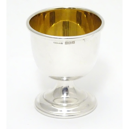 394 - A silver egg cup with gilded interior and weighted base. Hallmarked Birmingham 1963 maker Angora Sil... 