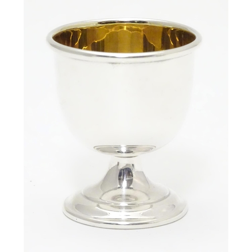 394 - A silver egg cup with gilded interior and weighted base. Hallmarked Birmingham 1963 maker Angora Sil... 