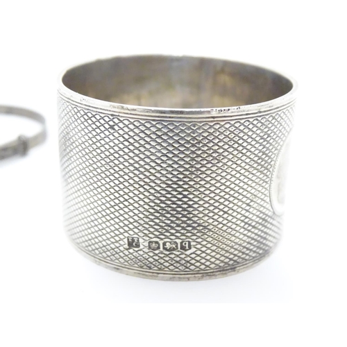 395 - An Art Deco silver napkin ring with engine turned decoration. Hallmarked Sheffield 1933 maker Thomas... 