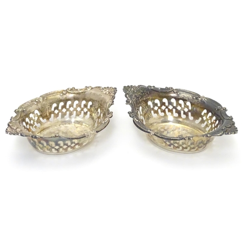 412 - A pair of small silver boat-shaped pin dishes with pierced and C scroll decoration.
Hallmarked Birmi... 