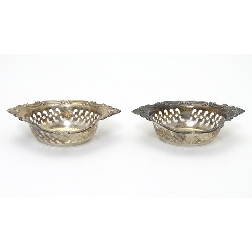 412 - A pair of small silver boat-shaped pin dishes with pierced and C scroll decoration.
Hallmarked Birmi... 