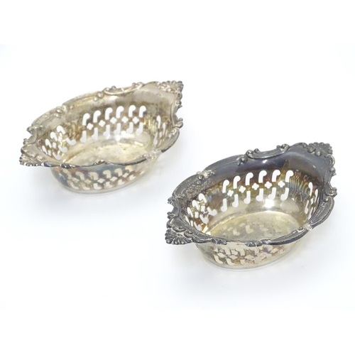 412 - A pair of small silver boat-shaped pin dishes with pierced and C scroll decoration.
Hallmarked Birmi... 