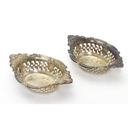 412 - A pair of small silver boat-shaped pin dishes with pierced and C scroll decoration.
Hallmarked Birmi... 