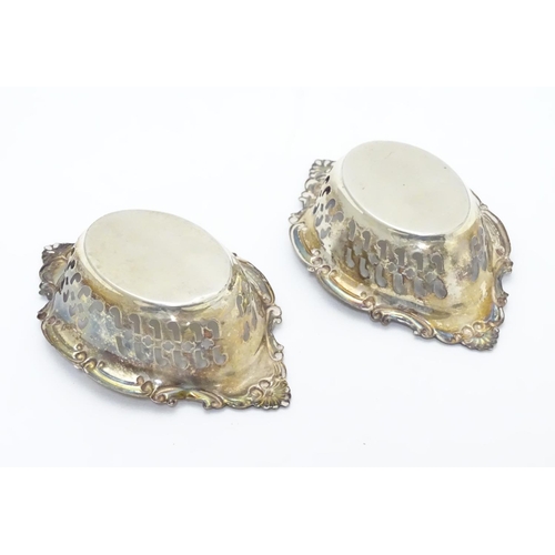 412 - A pair of small silver boat-shaped pin dishes with pierced and C scroll decoration.
Hallmarked Birmi... 