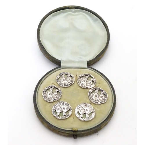 413 - A cased set of 6 white metal buttons. Marked to reverse with Registered design no 352928. each appro... 