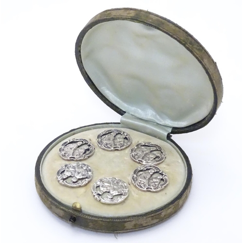 413 - A cased set of 6 white metal buttons. Marked to reverse with Registered design no 352928. each appro... 