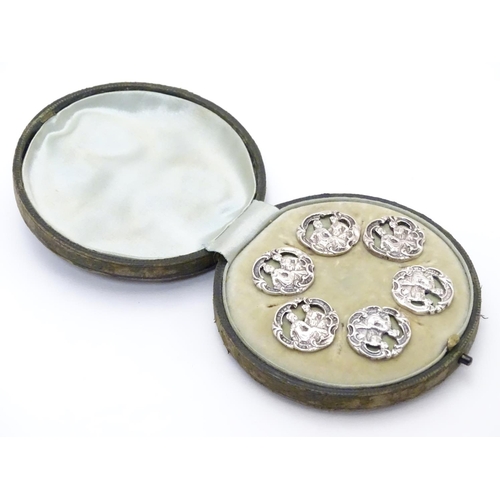 413 - A cased set of 6 white metal buttons. Marked to reverse with Registered design no 352928. each appro... 