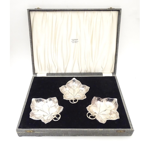 414 - Three WMF silver plated leaf-form pickle dishes with berry detail, each raised on three bun feet. WM... 