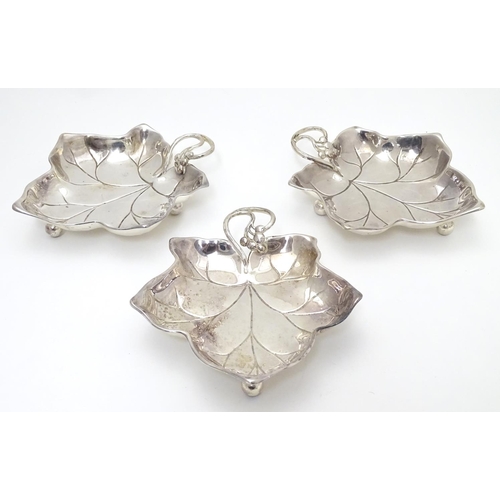 414 - Three WMF silver plated leaf-form pickle dishes with berry detail, each raised on three bun feet. WM... 